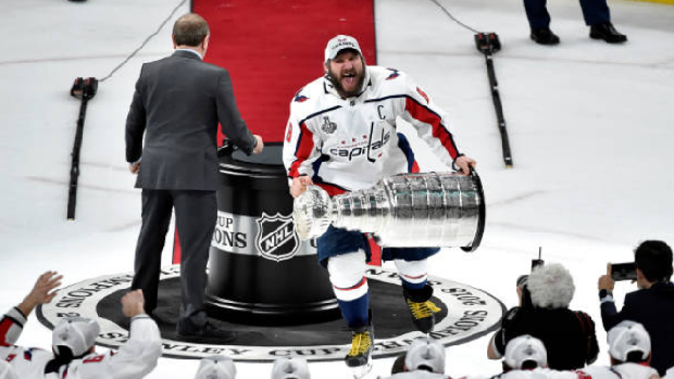 Alex Ovechkin brings the Stanley Cup to his teammates.