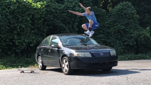 Guy jumps over car