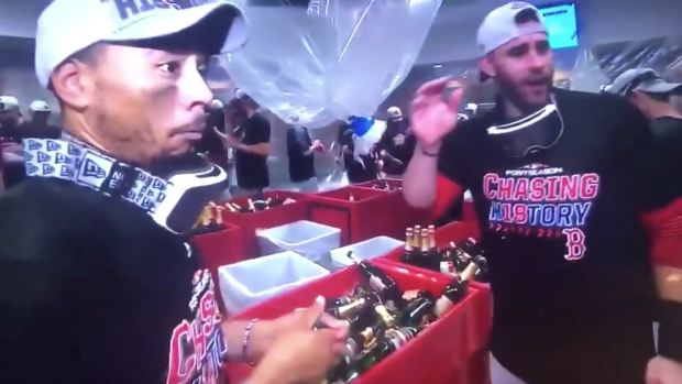 Mookie Betts accidentally hit a NESN reporter with his champagne cork  during the Red Sox clubhouse celebration