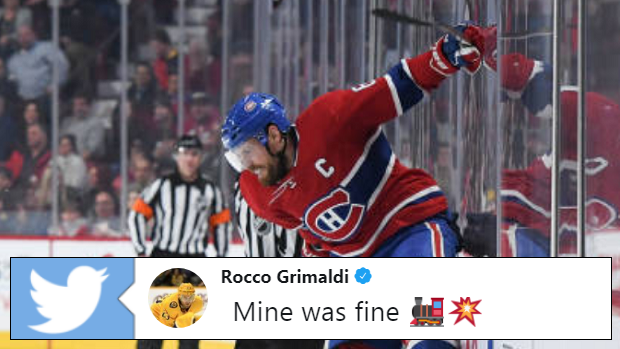 Shea Weber body-checks Rocco Grimaldi into the boards.