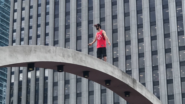 People Are Climbing The Arches Above Nathan Phillips Square At The Raptors Parade Article Bardown