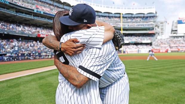 CC Sabathia throws a ceremonial first pitch before a baseball game