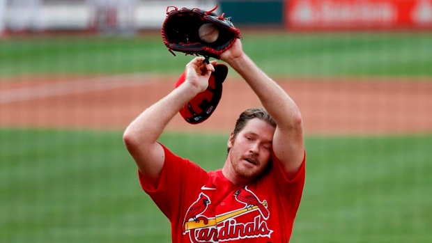 Miles Mikolas of the St. Louis Cardinals splashes water on his