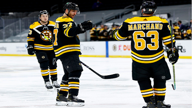 Brad Marchand and Patrice Bergeron celebrate a goal