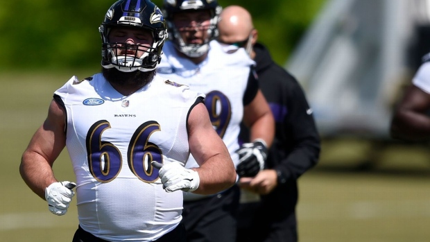 Baltimore Ravens guard Ben Cleveland (66) heads out to the field