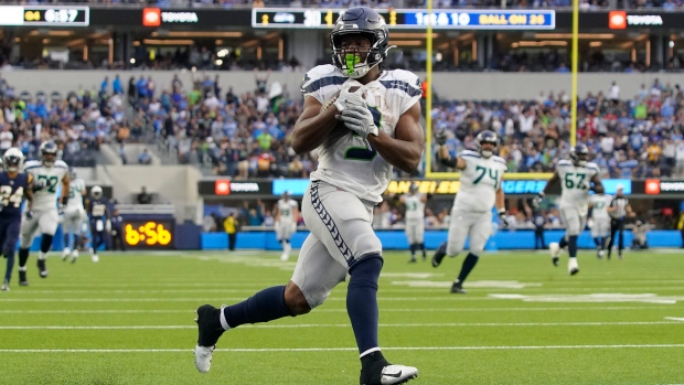 Seattle Seahawks running back Kenneth Walker III powers across the goal  line for a 1-yard TD