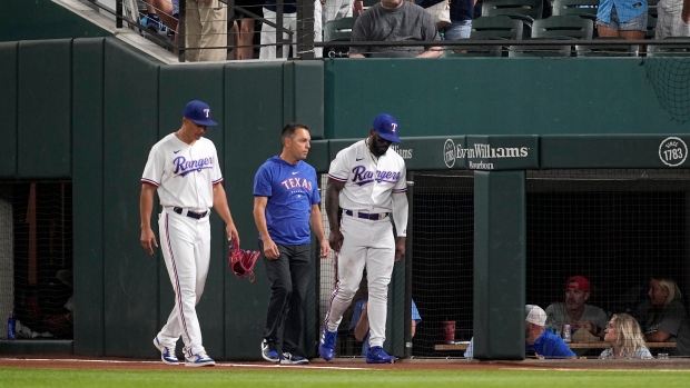 Adolis García exits with right knee injury in Rangers' loss to Astros