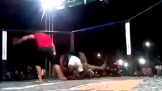 A massive brawl ensues after an MMA cornerman jumped the fence to defend his fighter.