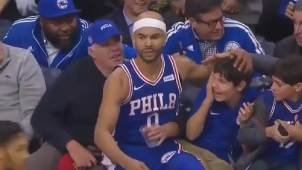 Sixers player falls into seats, literally just hangs out ...