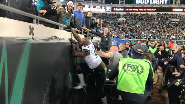 Jags fan runs onto field, gets his money worth dapping players